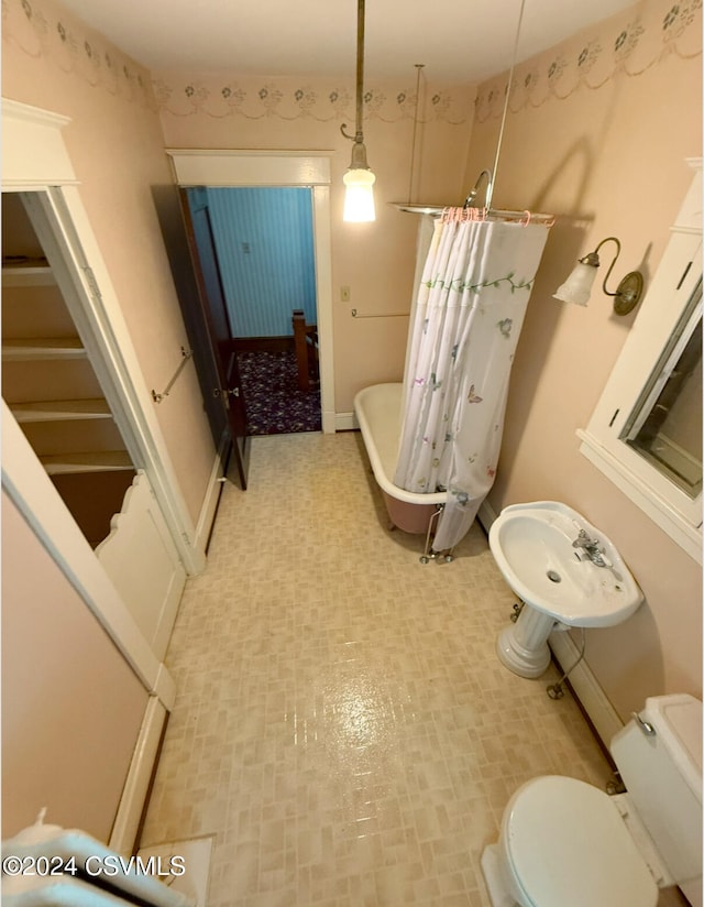 bathroom featuring toilet and a tub