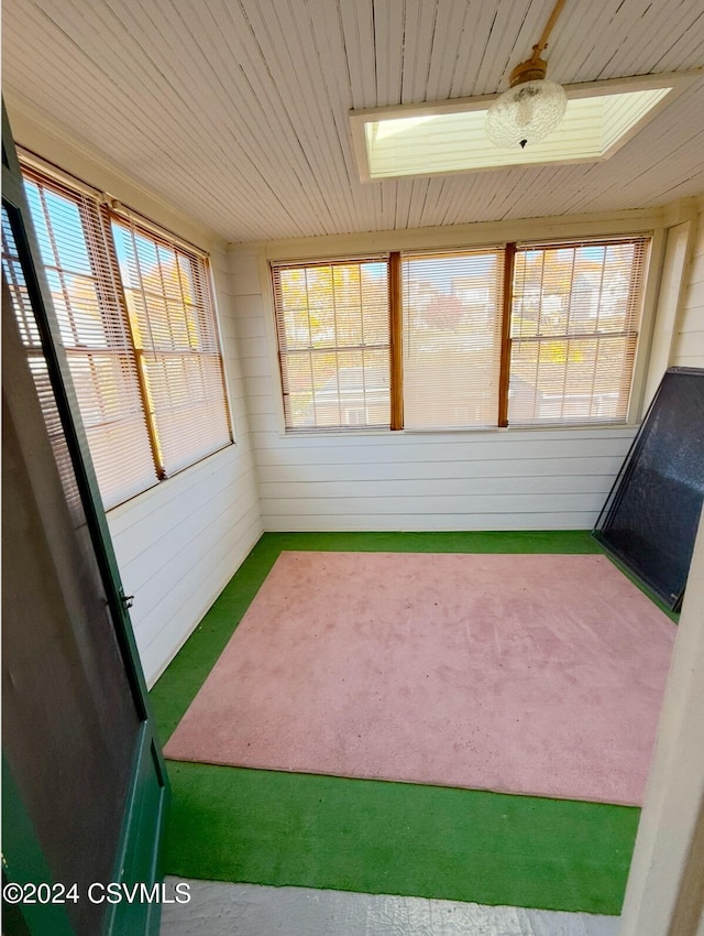 unfurnished sunroom with plenty of natural light and wood ceiling