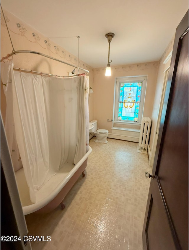 bathroom with radiator heating unit, toilet, and shower / tub combo with curtain