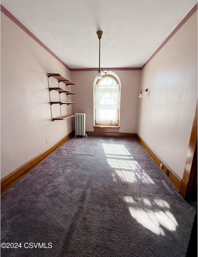 interior space with carpet flooring, radiator heating unit, and ornamental molding