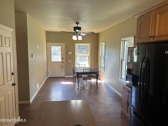 dining area with dark hardwood / wood-style floors and ceiling fan