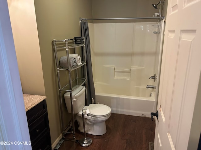 full bathroom with hardwood / wood-style flooring, shower / bath combination with curtain, toilet, and vanity