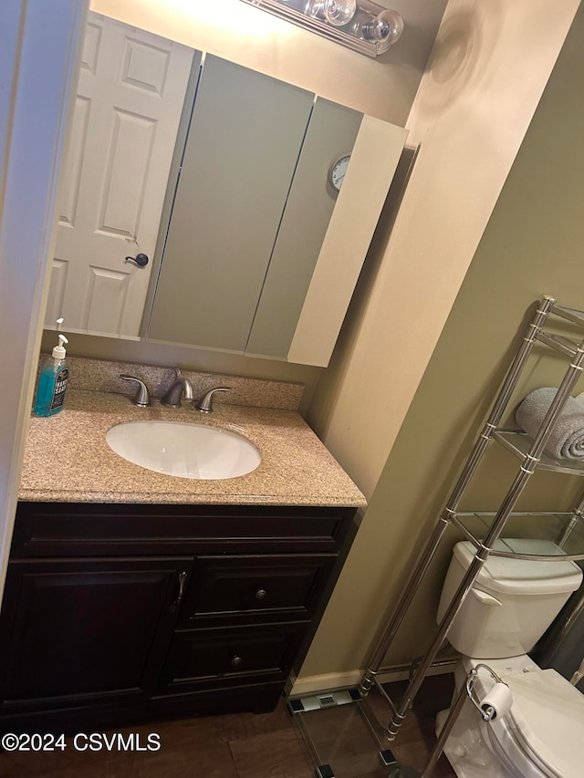 bathroom with vanity and toilet