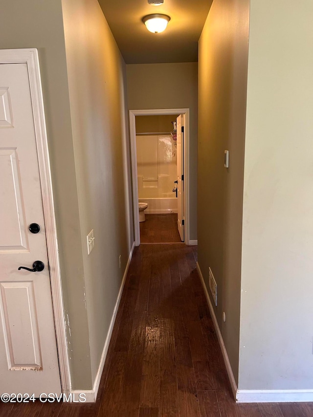 corridor with dark hardwood / wood-style floors