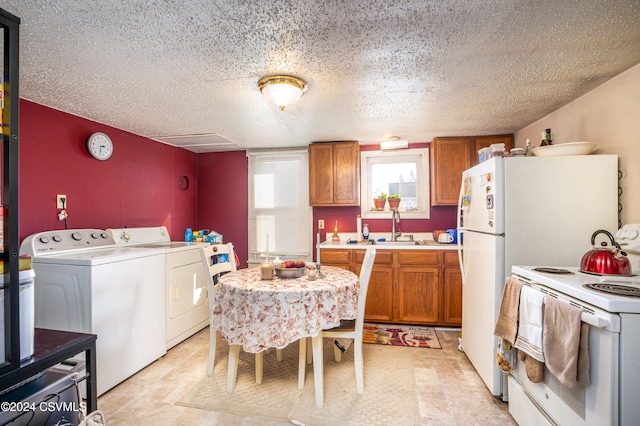 kitchen with independent washer and dryer, electric range, a textured ceiling, and sink