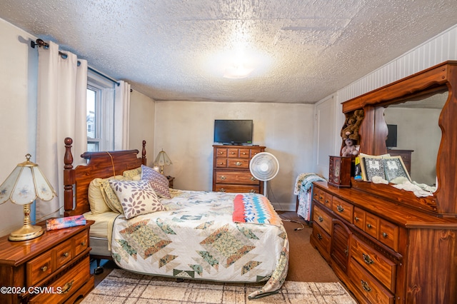 bedroom with hardwood / wood-style floors and a textured ceiling