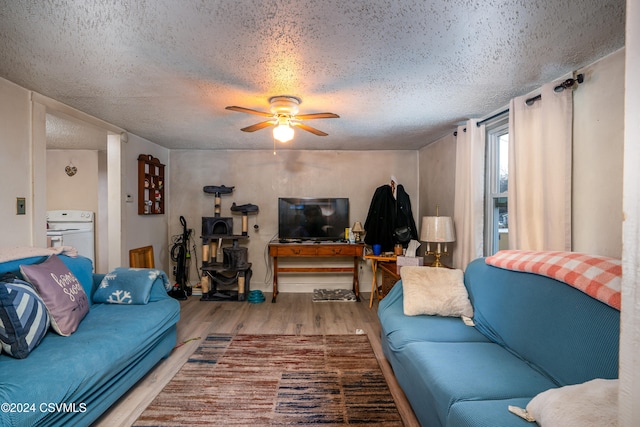 living room featuring ceiling fan, a textured ceiling, and light hardwood / wood-style flooring