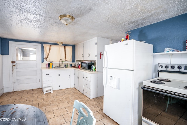 kitchen featuring a textured ceiling, white appliances, white cabinetry, and sink