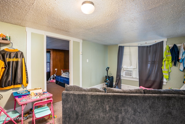 carpeted living room featuring cooling unit and a textured ceiling