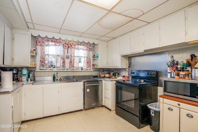 kitchen featuring a paneled ceiling, white cabinetry, sink, and appliances with stainless steel finishes