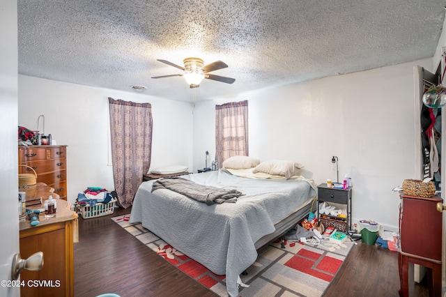 bedroom featuring ceiling fan, wood-type flooring, and a textured ceiling