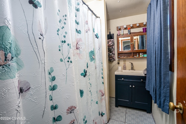 bathroom with tile patterned floors and vanity