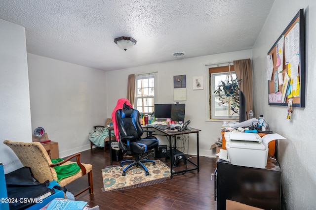 office area with dark hardwood / wood-style floors and a textured ceiling