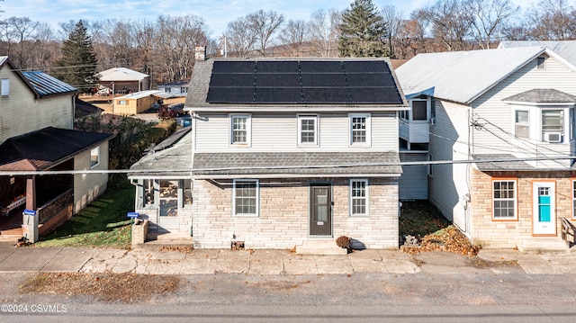 view of front property with solar panels