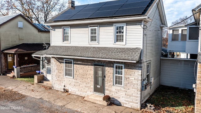 view of front facade with solar panels