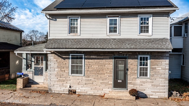 view of front of home featuring solar panels