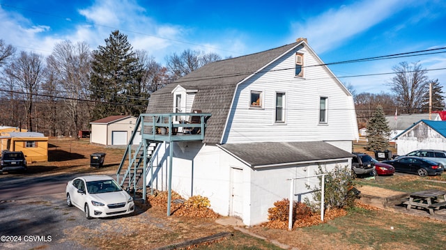 view of side of property featuring a storage shed