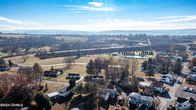 birds eye view of property featuring a water and mountain view