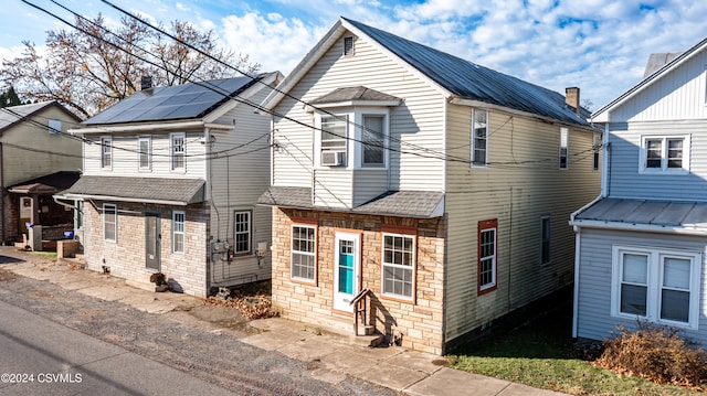 view of front facade featuring solar panels