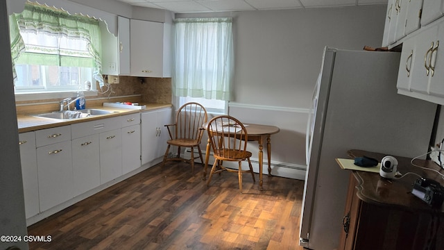 kitchen featuring white cabinetry, dark hardwood / wood-style flooring, a drop ceiling, and sink