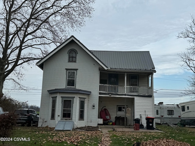 rear view of property with a balcony