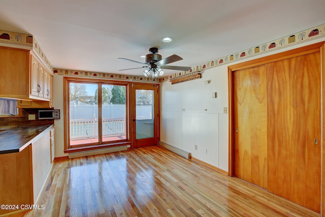 kitchen with a baseboard radiator, ceiling fan, and light hardwood / wood-style floors