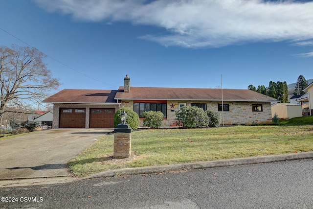 ranch-style house featuring a garage and a front lawn