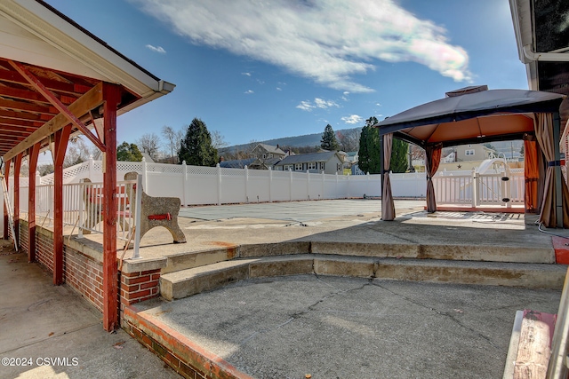 view of yard featuring a gazebo, a mountain view, and a patio