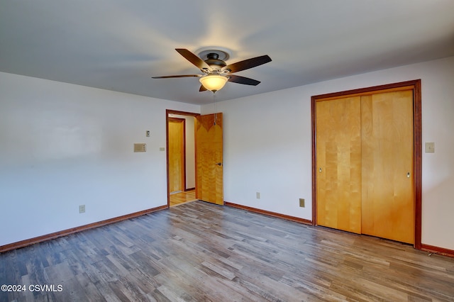 unfurnished bedroom with ceiling fan, a closet, and light wood-type flooring