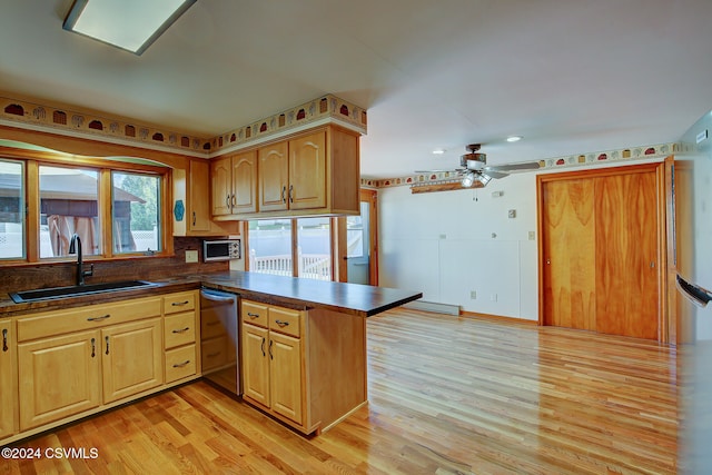 kitchen featuring sink, ceiling fan, light wood-type flooring, kitchen peninsula, and stainless steel appliances