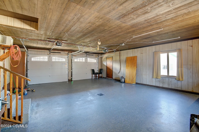 garage with wood walls, wood ceiling, and a garage door opener