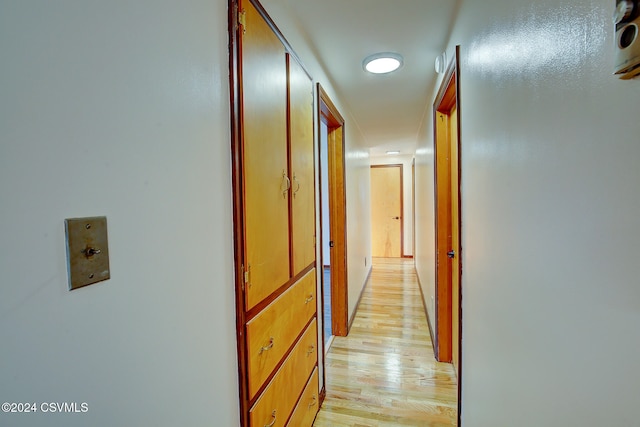 corridor with light wood-type flooring