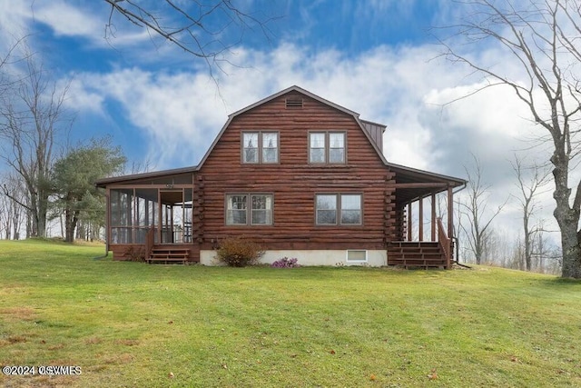 rear view of property with a lawn and a sunroom