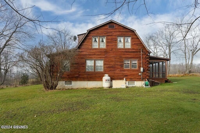 view of side of home featuring a yard and a sunroom