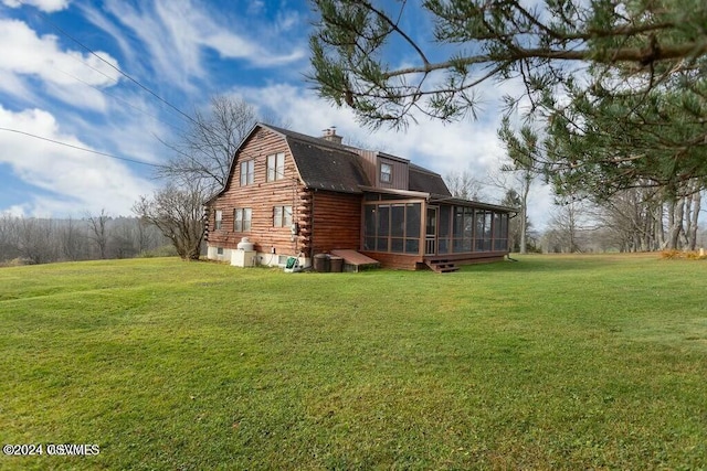 back of property with a lawn and a sunroom