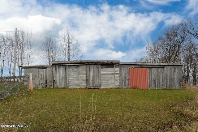 view of outdoor structure featuring a lawn