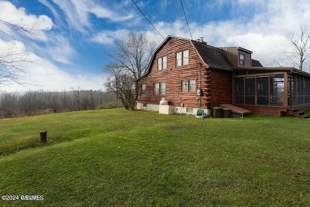 view of property exterior with a sunroom and a lawn