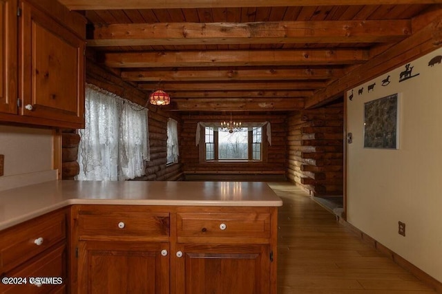 kitchen featuring kitchen peninsula, wood ceiling, an inviting chandelier, light hardwood / wood-style flooring, and beamed ceiling