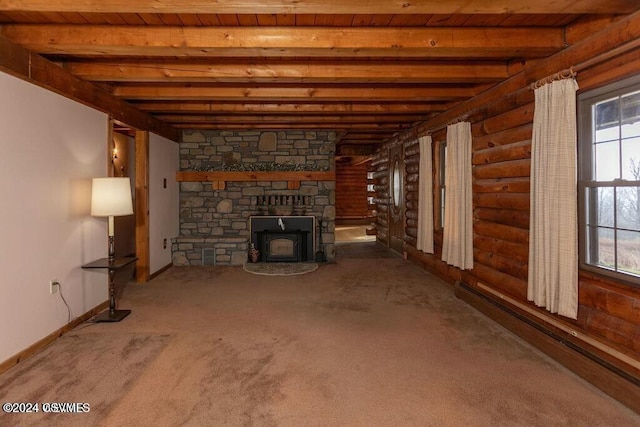 unfurnished living room with baseboard heating, carpet flooring, plenty of natural light, and beam ceiling