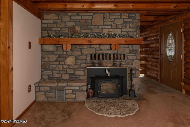 details with a wood stove, log walls, and carpet floors