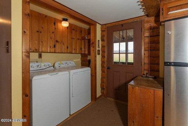 washroom featuring wooden walls, carpet, cabinets, and independent washer and dryer