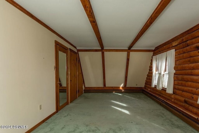 empty room featuring log walls, beamed ceiling, carpet floors, and a baseboard radiator