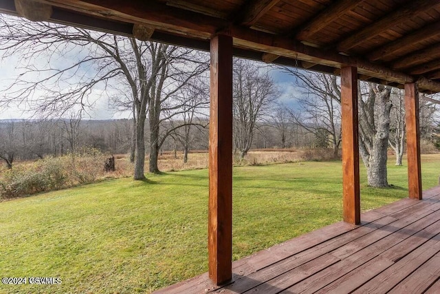 wooden deck featuring a yard