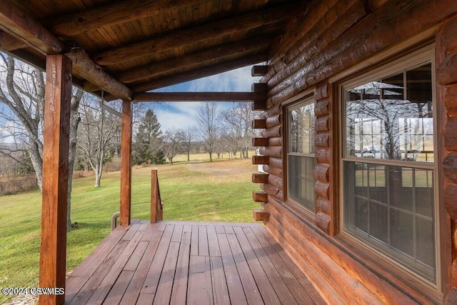 wooden deck featuring a yard