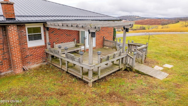 deck featuring a lawn, a rural view, and a pergola