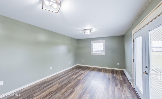 empty room with dark hardwood / wood-style flooring