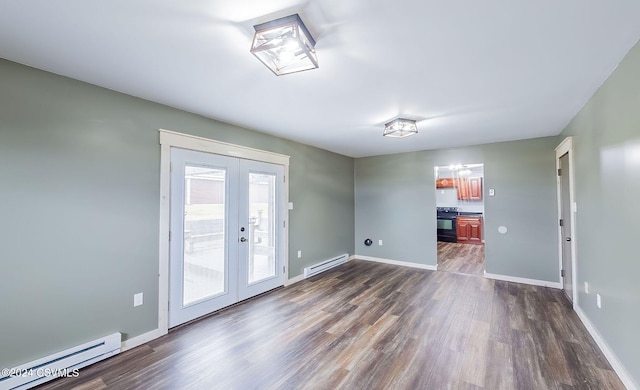 empty room with french doors, dark wood-type flooring, and a baseboard heating unit