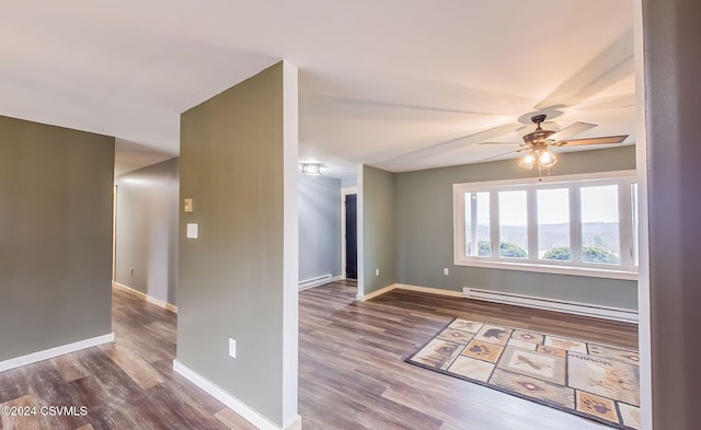 spare room with ceiling fan, hardwood / wood-style floors, and a baseboard radiator