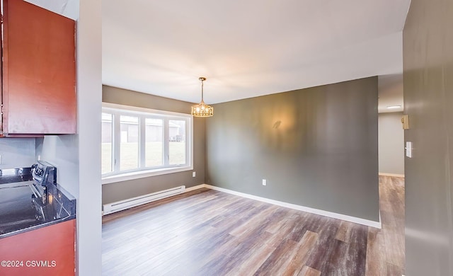 unfurnished dining area featuring hardwood / wood-style floors, a baseboard radiator, and a notable chandelier