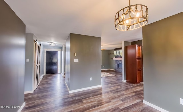 corridor with a chandelier and dark hardwood / wood-style flooring